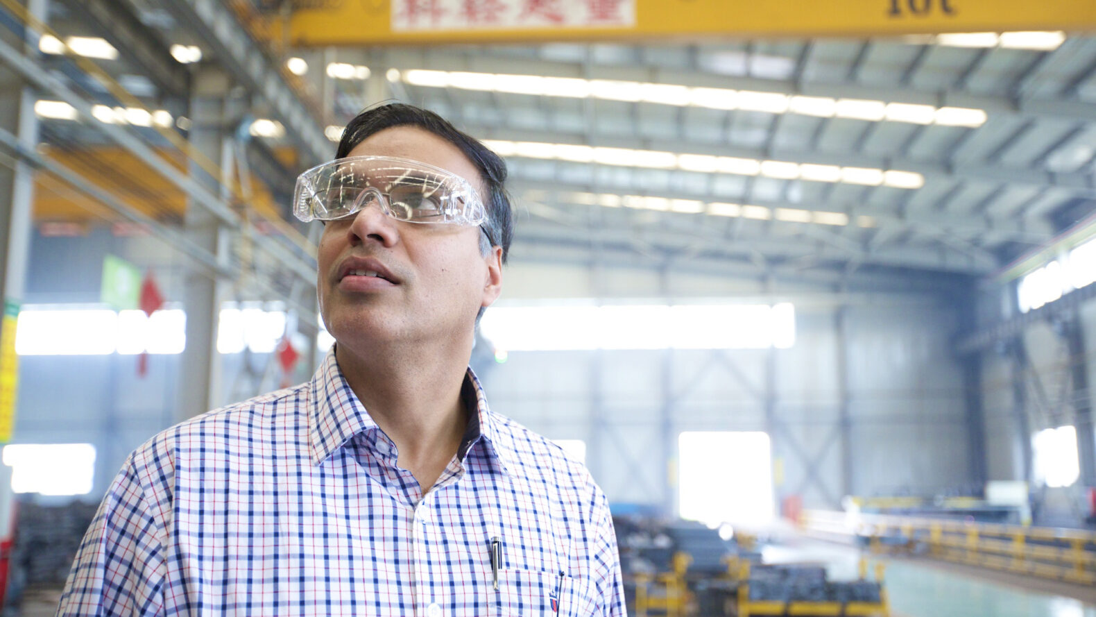 Professionally shot photo of employee with safety glasses in an industrial workplace