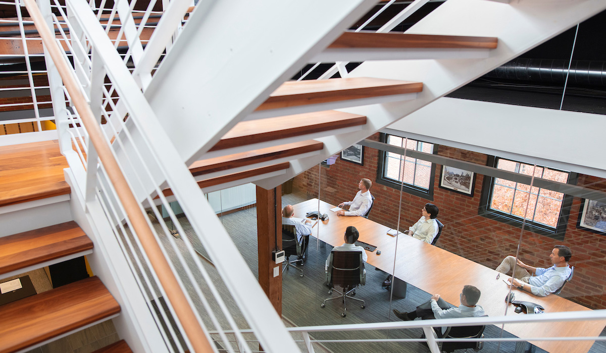 professional wide photo of corporate office setting with transparent meeting room