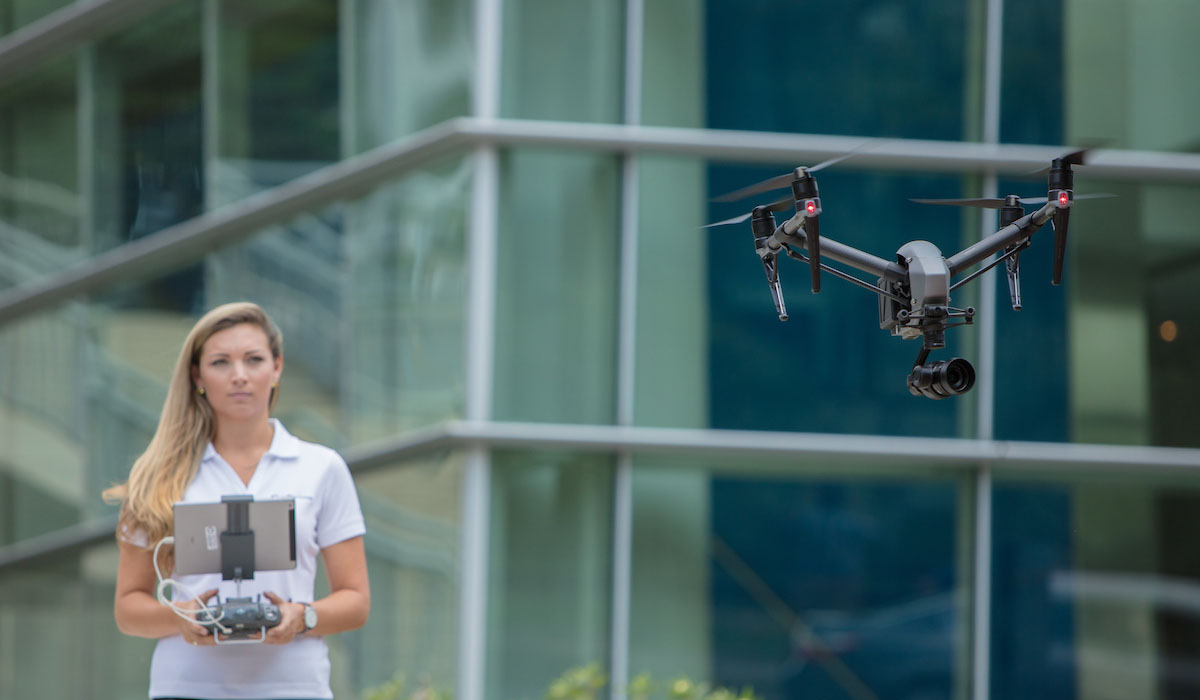 corporate employee flying drone camera