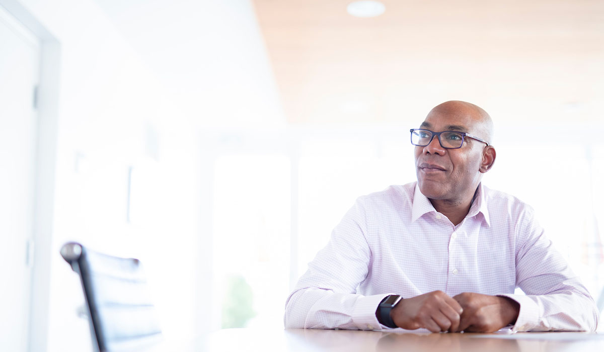 Professional photo of businessman sitting at table in conference room