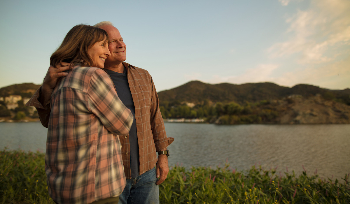 production still of couple gazing out at lake