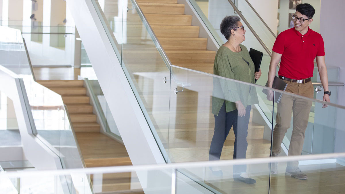 corporate coworkers walking down steps talking