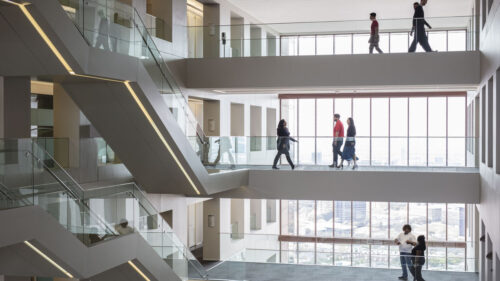 corporate employees walking on multiple levels of open space office