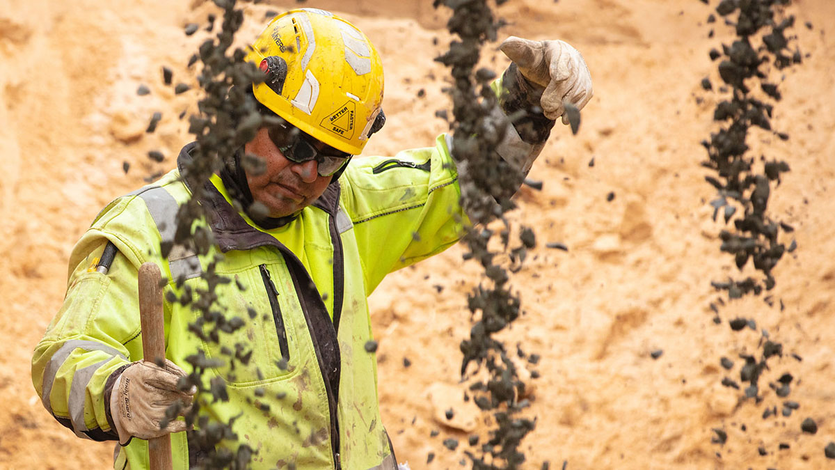 Construction worker in neon yellow jacket supervising work