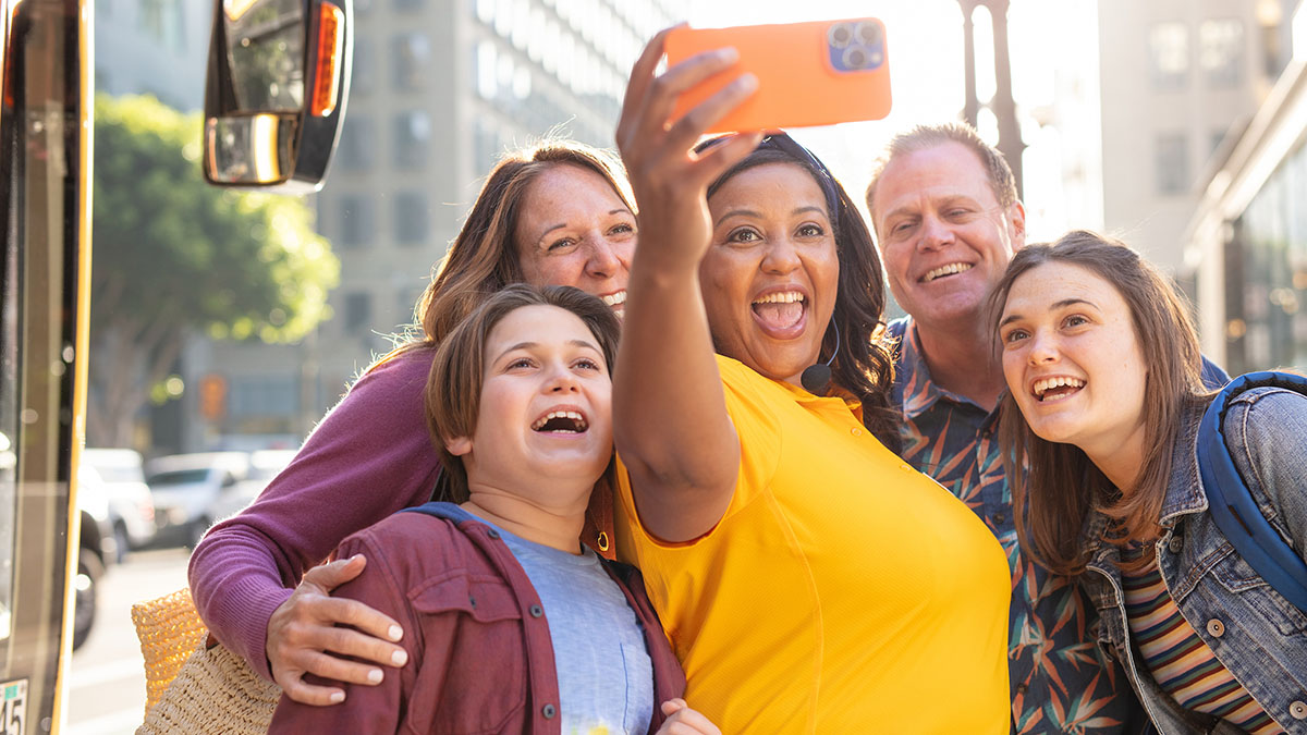 Family posing for selfie with tour guide