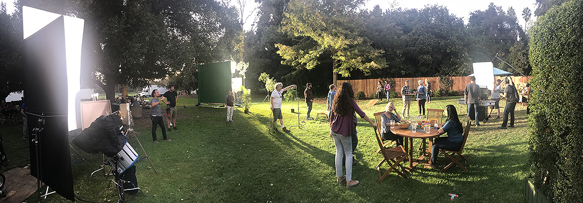 behind the scenes shot of a commercial video shoot in a backyard setting