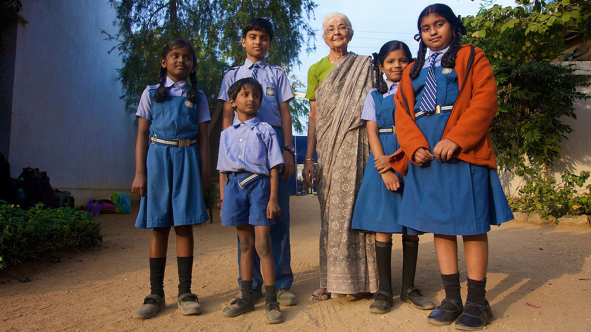 group of students wearing uniform next to teacher