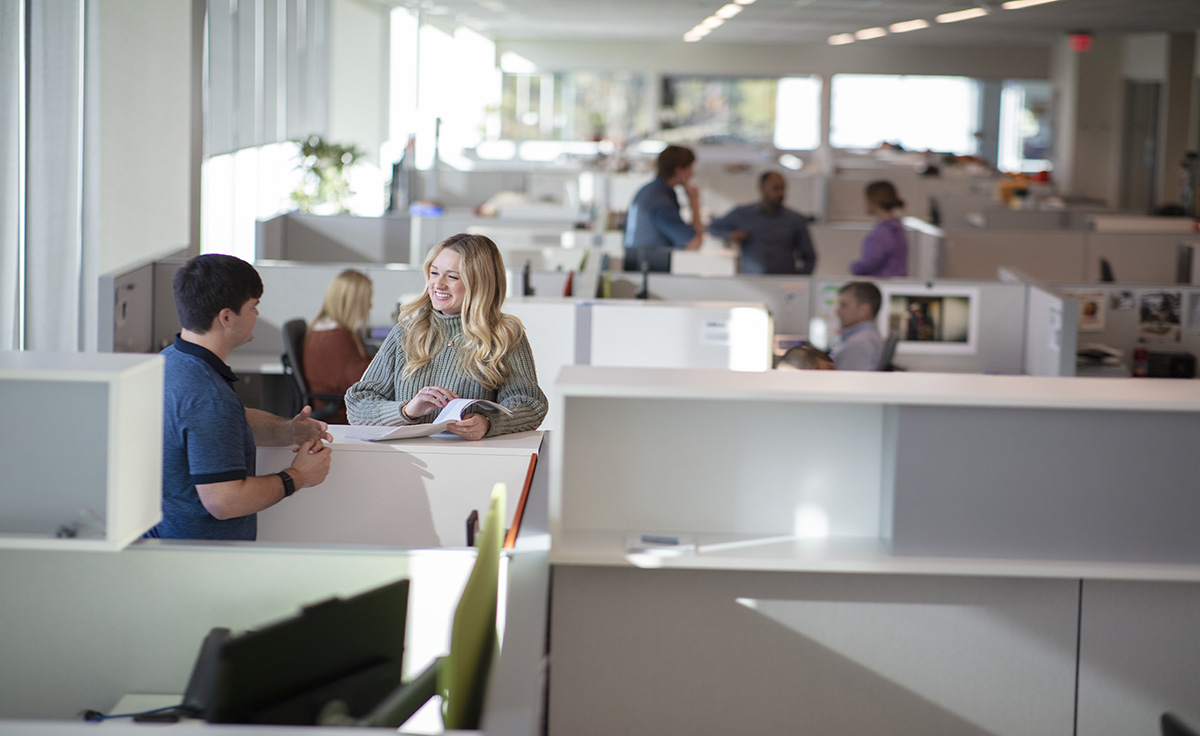 two groups of employees collaborating at a corporate office space