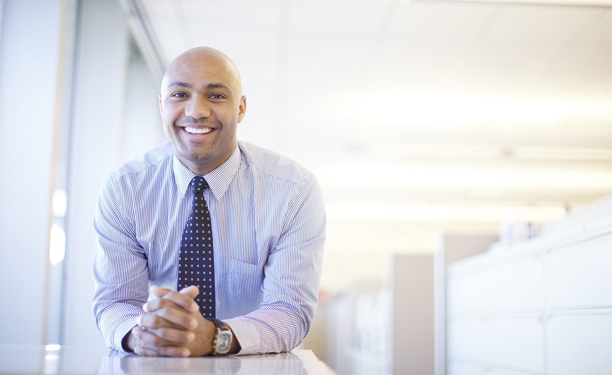 commercial portrait of corporate employee in pinstripe long sleeve shirt and tie