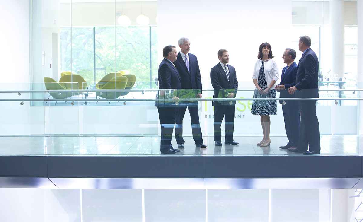 group of commercial employees talking in hallway