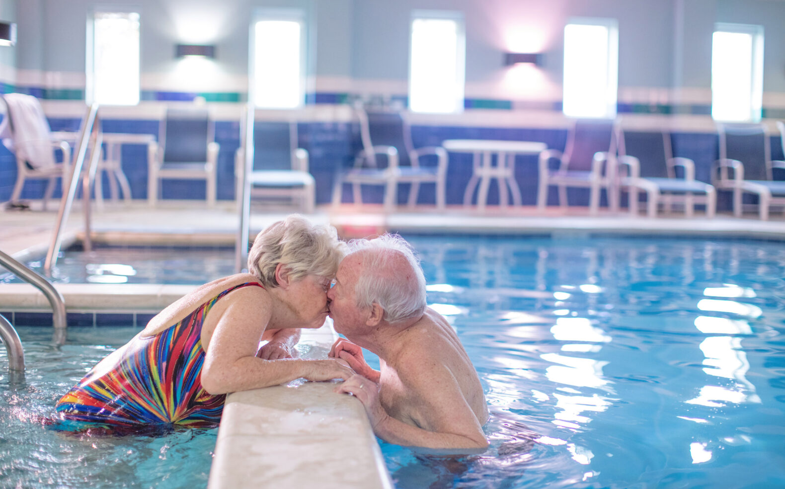 Senior couple kissing in pool