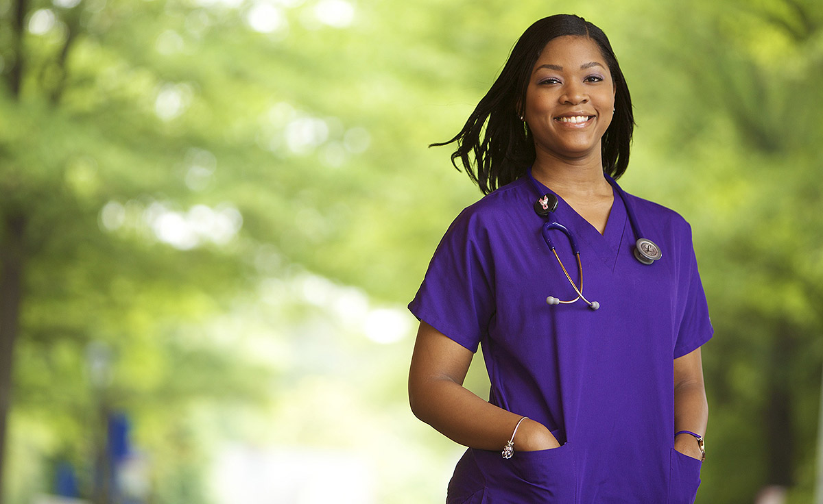 portrait of female medical professional in purple scrubs