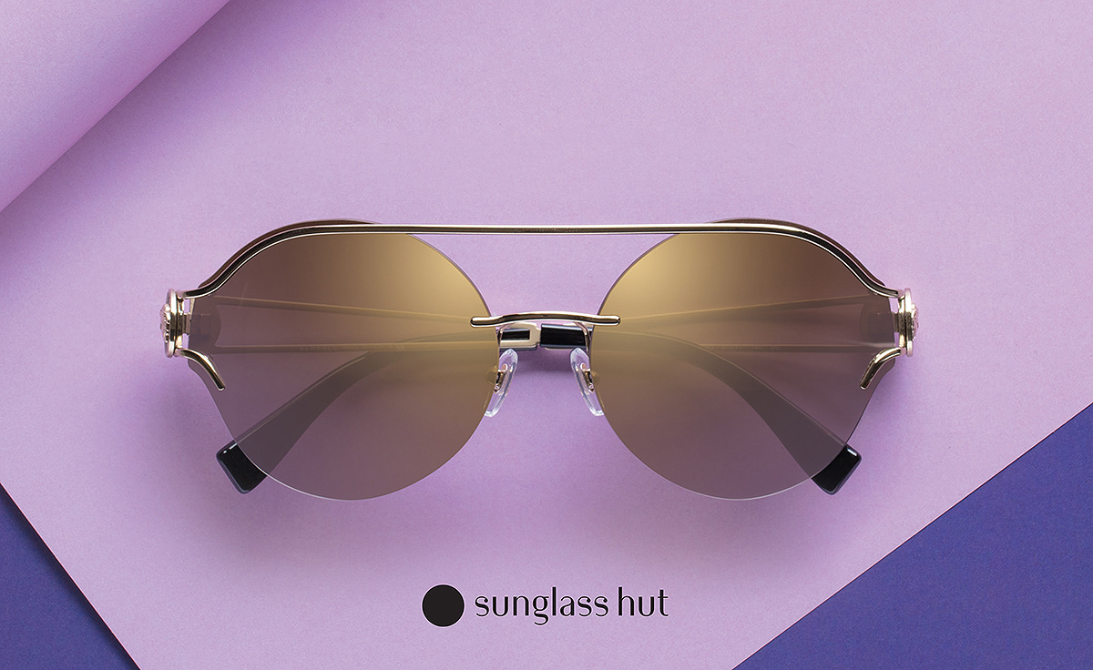 pair of sunglass hut sunglasses with purple background