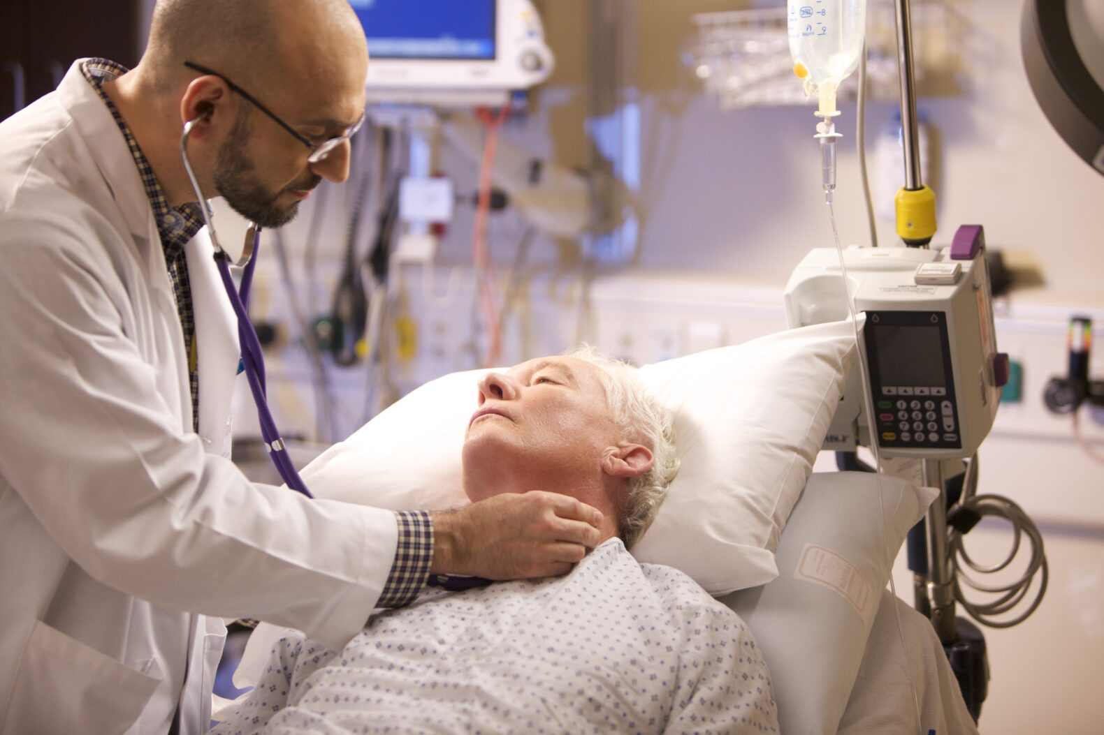 doctor using stethoscope on patient