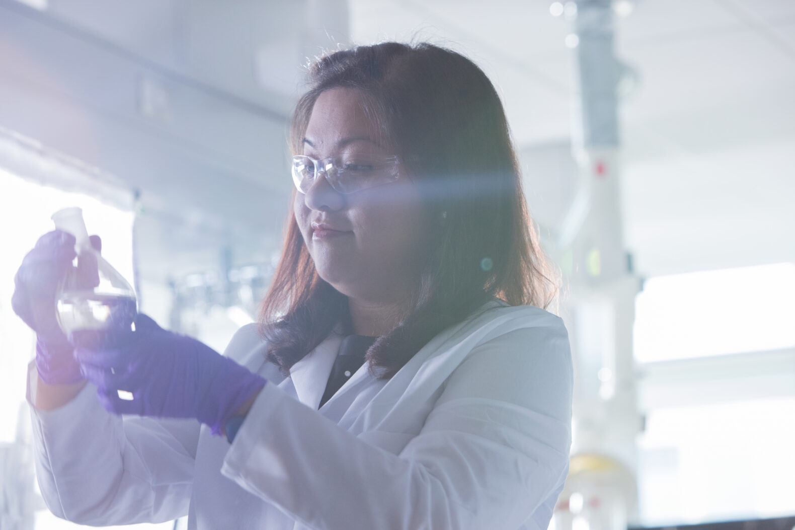 pharmaceutical professional working with glass tube in lab