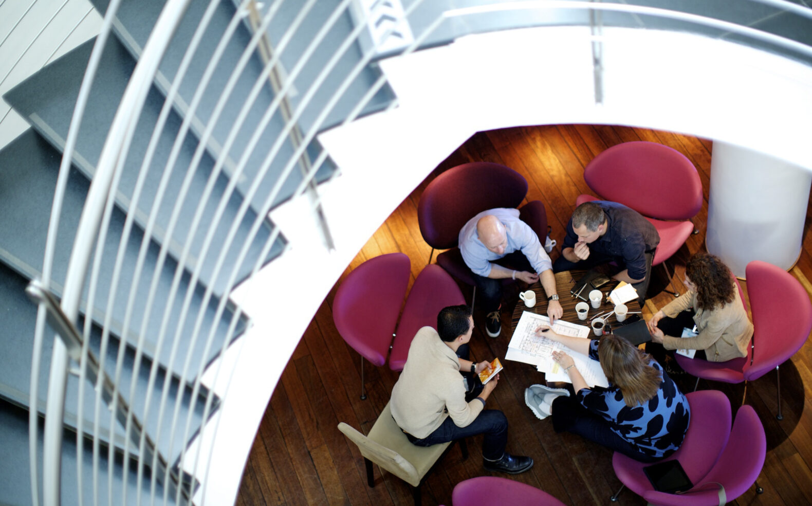 group of employees collaborate on marketing campaign at table