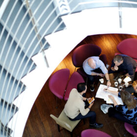 group of employees collaborate on marketing campaign at table