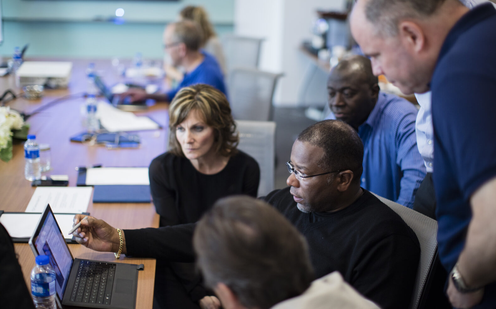 group of employees collaborating on marketing campaign in office